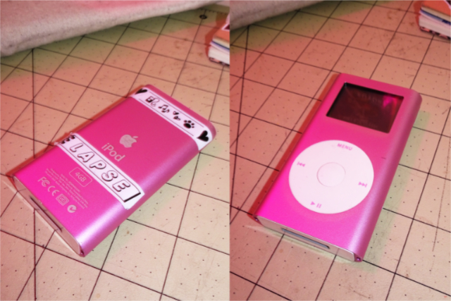 Front and back view of the iPod mini, a rectangular mp3 player a little over three inches tall with a two-color display and click wheel controls.